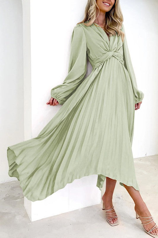 Pleated long sleeve dress in soft green, perfect for women’s boutique fashion.
