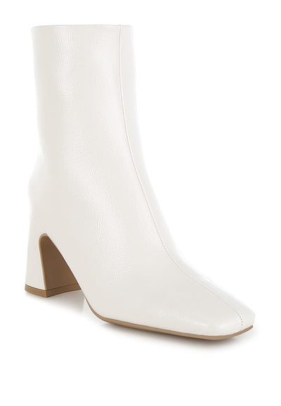 Stylish women’s boutique white ankle boots with a modern square toe and block heel, perfect for trendy outfits.