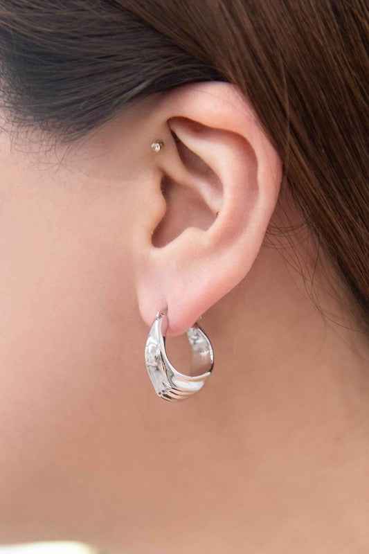 Ruched Hoop Earrings showcasing silver texture in women’s boutique