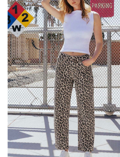 Trendy women's clothing featuring a stylish white crop top and leopard print wide-leg pants at a women’s boutique.