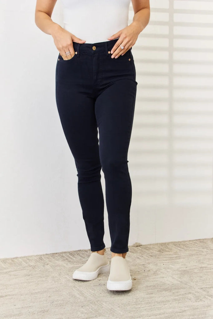 Judy Blue Full Size Garment Dyed Tummy Control Skinny Jeans featured in a women's boutique setting, showcasing modern women's fashion.