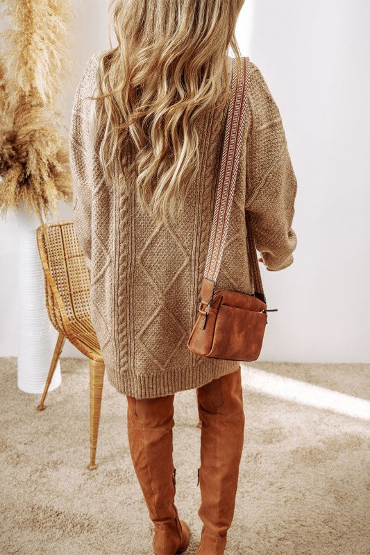 Women’s boutique Cable Knit Drop Shoulder Sweater Dress in beige.