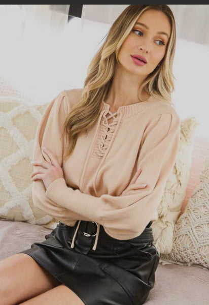 Lace-Up Style Round Neck Ribbed Hem Sweater worn with a black skirt, showcasing trendy women's clothing in a women's fashion boutique.